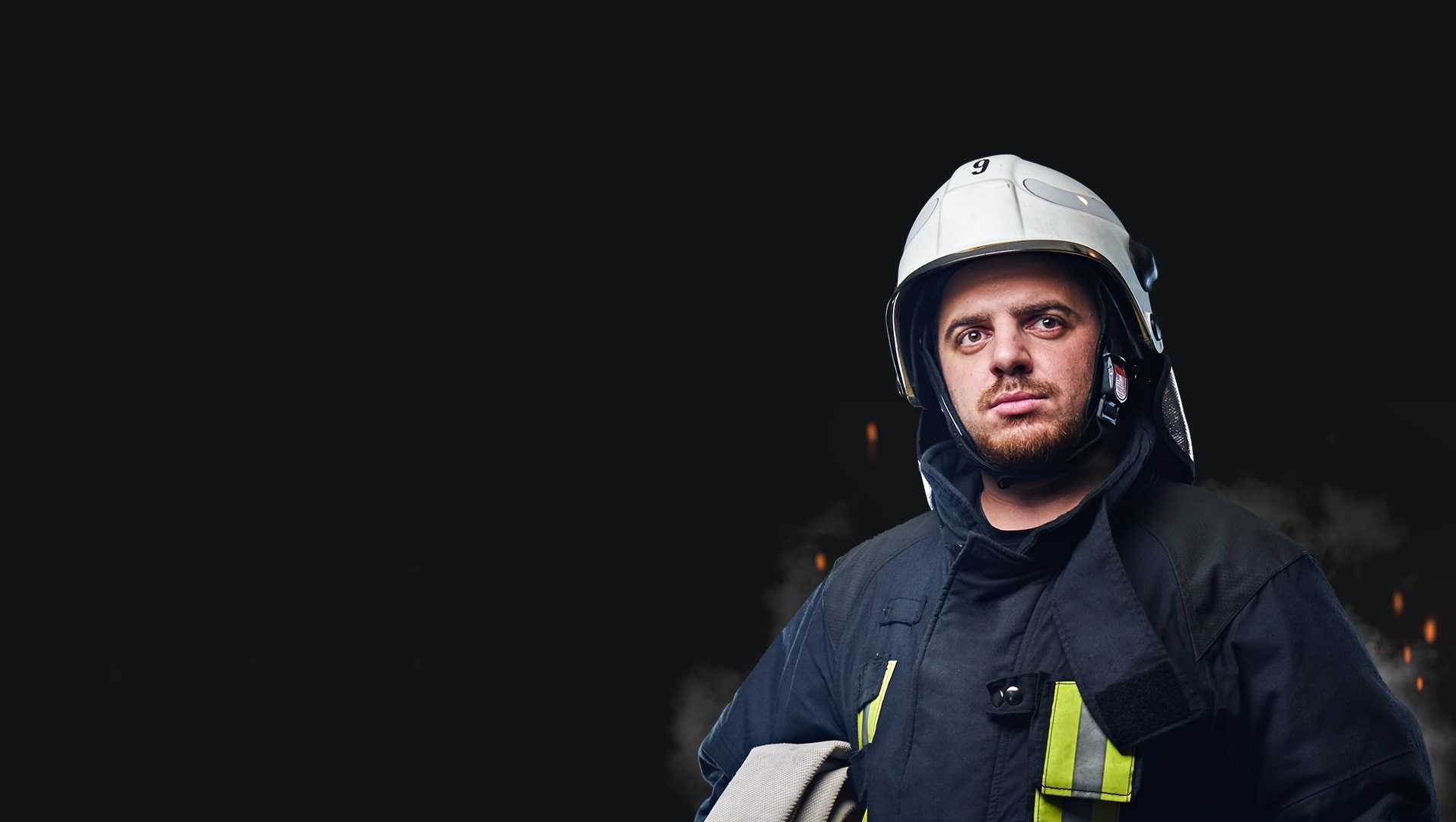 Fully equipped firefighter on a black background